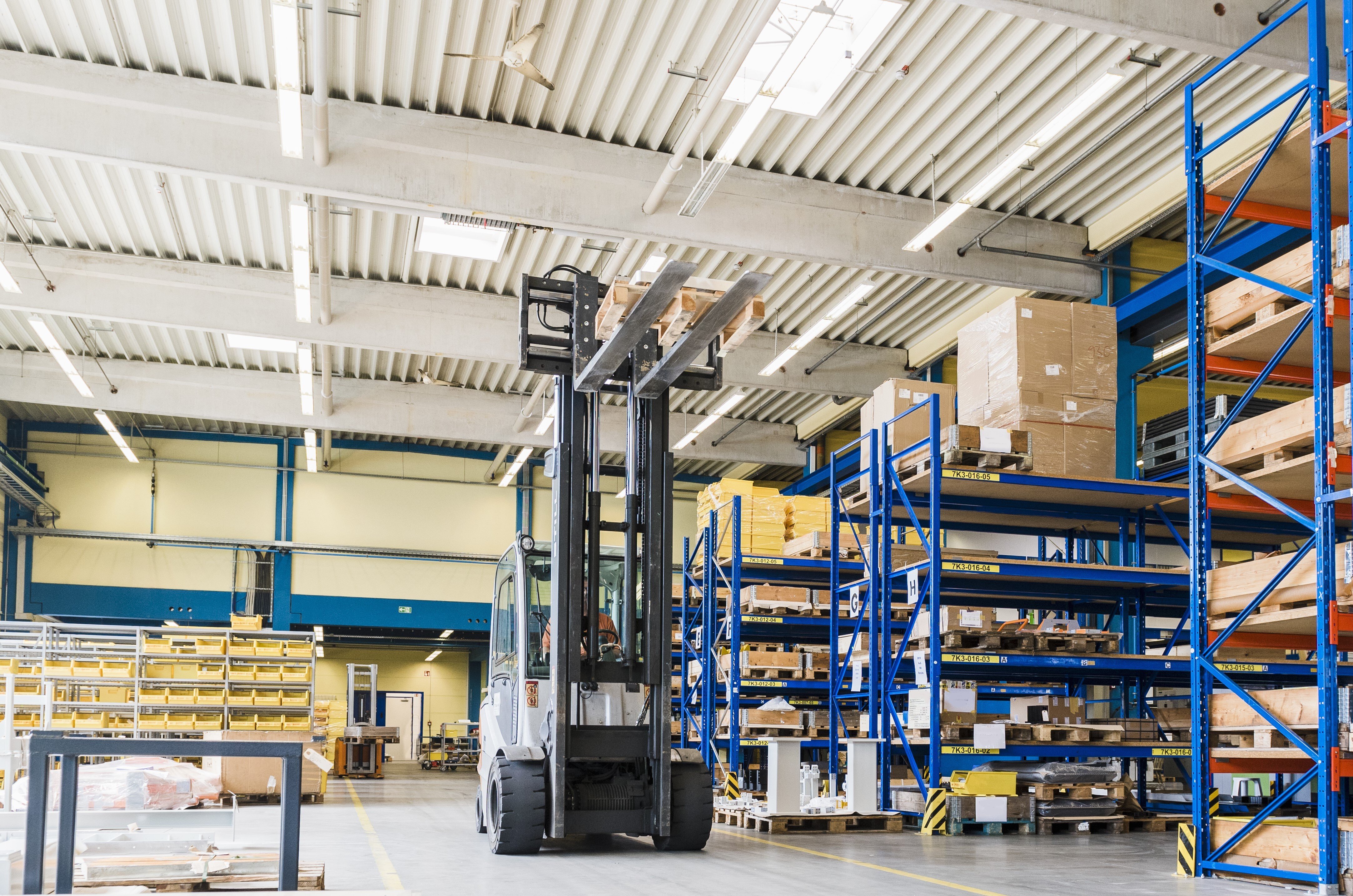 forklift-transporting-goods-inside-a-warehouse-fac-2026-03-09-04-35-19-utc (1)